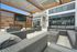 Outdoor TV lounge with pergola at Seasons at Plainfield Apartments in Plainfield, Illinois.