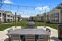 Outdoor resident seating area and grilling station at Seasons at River View Apartments in Pleasant Prairie, Wisconsin.