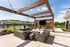 Outdoor pergola lounge with seating and TV at Seasons at Franklin apartments in Franklin, Wisconsin.