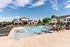 Resort-style outdoor pool with sundeck and lounge chairs at Seasons at Franklin apartments in Franklin, Wisconsin.