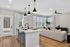 an island, bright cabinetry and contemporary finishes. Modern kitchen at Echelon at Cary apartments