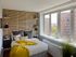 Arabella 101, interior, bedroom, large window, yellow blanket, accent wall, wood floor