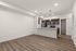 Modern open-concept apartment with elegant wooden flooring, stylish kitchen with stainless steel appliances, and ample pantry storage.