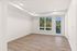 Bright and airy living room with large windows showcasing scenic views, featuring elegant hardwood floors and recessed lighting.