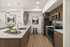 Modern kitchen with sleek stainless steel appliances, elegant wood cabinetry, and a stylish quartz island featuring lush greenery and a bowl of fresh apples.