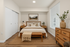 Cozy and elegant bedroom with modern wooden furniture, soft lighting, and stylish decor for a relaxing atmosphere.