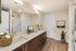 Elegant bathroom featuring a sleek double vanity with a warm wood finish, stylish modern fixtures, and cozy decor accents.