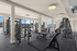Modern gym with state-of-the-art fitness equipment, bright windows, and sleek design for an energizing workout experience.