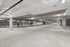 Expansive underground parking garage with ample lighting and organized spaces, offering secure and convenient parking options.