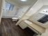 Modern bathroom with elegant fixtures, a spacious bathtub, and sleek wood flooring.