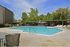 Inviting outdoor pool area with lounge chairs and greenery, ideal for relaxation and recreation in a serene setting.