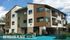 Modern apartment complex at Meridian Place, featuring stylish architecture with wood accents and ample balconies, located at 820 B Street, Davis, California.