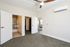 Bright and spacious bedroom with plush carpet, ceiling fan, and convenient access to private bathroom and balcony, perfect for modern living.