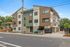 Modern multi-story apartment building with sleek architectural design and inviting exterior at Meridian Place.