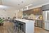 Elegant open-plan kitchen and living area with stylish lighting, modern cabinetry, and inviting dining island.