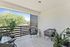 Chic and modern balcony with stylish seating, lush greenery, and serene views, perfect for relaxation and outdoor enjoyment.