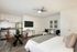 Modern studio apartment with open-plan design, featuring a cozy bed, sleek kitchen, and stylish dining area.