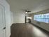 Bright apartment with modern flooring, cozy kitchen, and expansive windows offering natural light.
