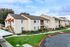 Beautiful suburban apartment complex with charming architecture, lush landscaping, and peaceful surroundings.