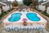 Inviting apartment complex with two vibrant swimming pools surrounded by seating areas and lush greenery, perfect for relaxation and gatherings.