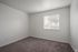 Bright and inviting bedroom with carpet and a large window offering an abundance of natural light.