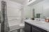 Modern bathroom featuring a sleek vanity, and elegant lighting.