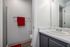 Elegant bathroom with modern fixtures, featuring a sleek vanity.