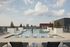 Stunning rooftop pool offering panoramic city views, surrounded by sleek lounge chairs and modern design.