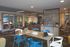 Modern co-working area with vibrant blue chairs, meeting room, and stylish decor.