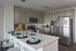 Contemporary kitchen with stainless steel appliances, elegant cabinetry, and a stylish island with seating.