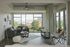 Chic living room with modern decor, large windows, and a city view.