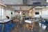 Spacious recreation lounge with billiards, foosball table, and modern seating areas.
