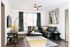 Modern and inviting living room with sleek leather sofa, stylish artwork, and abundant natural light.