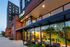Modern urban residence with sleek architecture and welcoming facade at dusk.