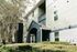 Charming apartment building exterior with modern architecture, lush greenery, and inviting entrance.