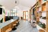 Chic and modern apartment lobby with stylish wooden accents, cozy bar seating, and welcoming natural light from large windows.