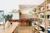 Chic and inviting open-concept kitchen and dining area with modern bar stools, vibrant decor, and ample natural light.