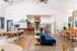 Inviting communal space featuring a modern dining area, vibrant seating, and a sleek kitchen with a contemporary design.