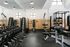 Modern fitness center equipped with free weights, weight machines, and a punching bag, offering a well-rounded workout experience.
