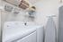Modern laundry room with sleek appliances, organized shelving, and stylish decor for efficient living.