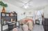 Charming and serene bedroom with stylish decor, featuring a cozy bed, elegant desk, and ample natural light.