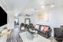 Inviting modern living room with plush leather seating, stylish decor, and vibrant cushions in a cozy apartment setting.