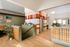 Chic lobby area with colorful plaid wall, modern reception desk, and lush green plants for a welcoming atmosphere.