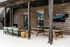 Chic outdoor entertainment area featuring a ping pong table, cozy seating, and ambiance with string lights.