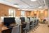 Modern coworking space with sleek workstations, ambient lighting, and contemporary design accents.