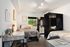 Modern bedroom with two cozy beds, stylish decor, spacious closet, and a functional work desk, perfect for comfortable living.