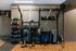 Modern fitness area with punching bag, weights, vibrant workout mats, and exercise equipment on wooden flooring for a dynamic workout experience.