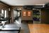 Modern apartment gym featuring state-of-the-art cardio equipment and vibrant weightlifting area, enhanced by natural light and championship banners for motivation.