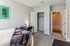 Cozy bedroom with plush carpeting, modern decor, and a sleek workspace offering a tranquil retreat.