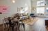 Bright and modern open-concept living area featuring stylish decor, sleek dining space, and abundant natural light.
